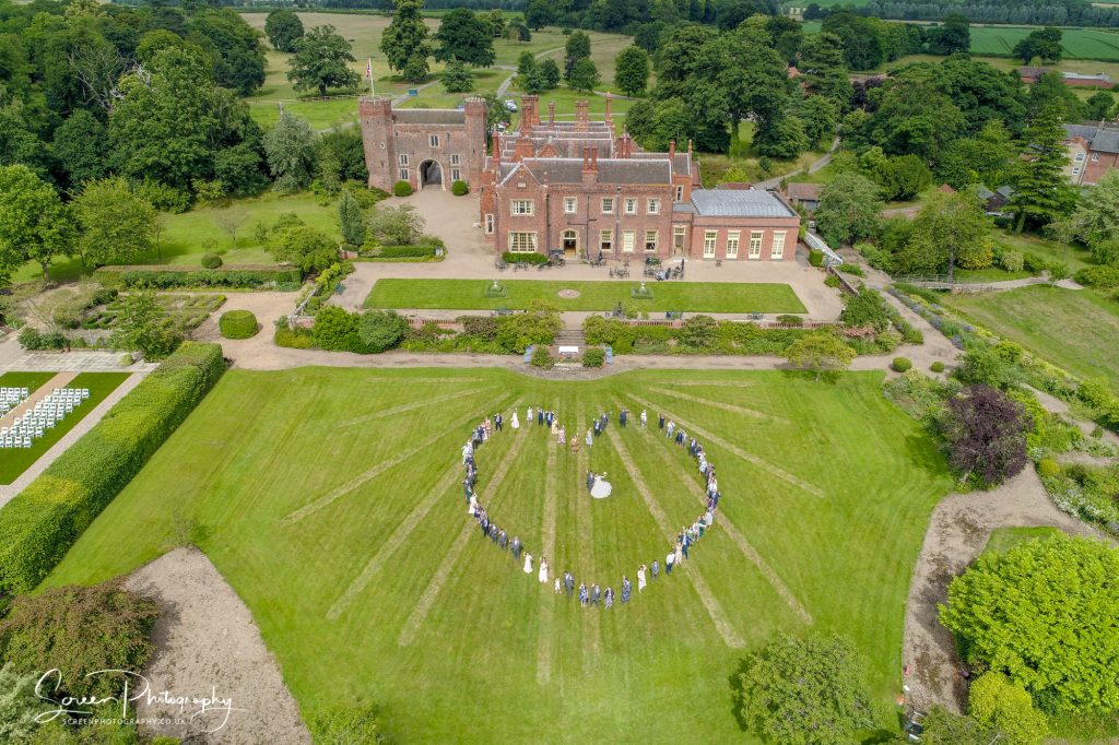 Heart shape drone wedding full group photograph at Hodsock Priory Nottinghamshire 