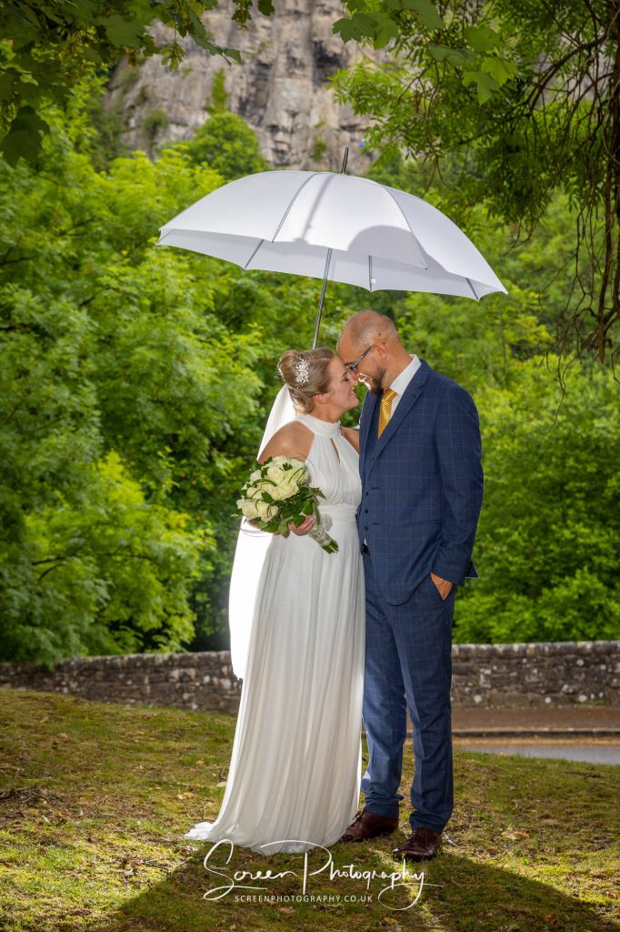 New Bath Hotel Matlock married wedding couple in rain with umbrella
