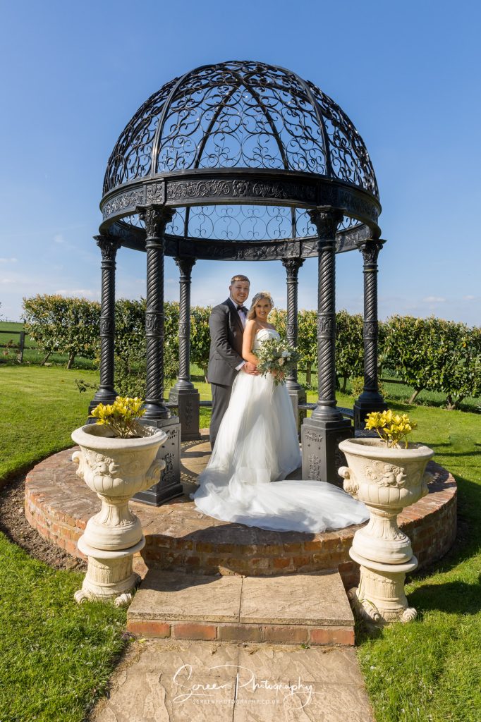married wedding couple at Swancar Farm Country House outside in pagoda