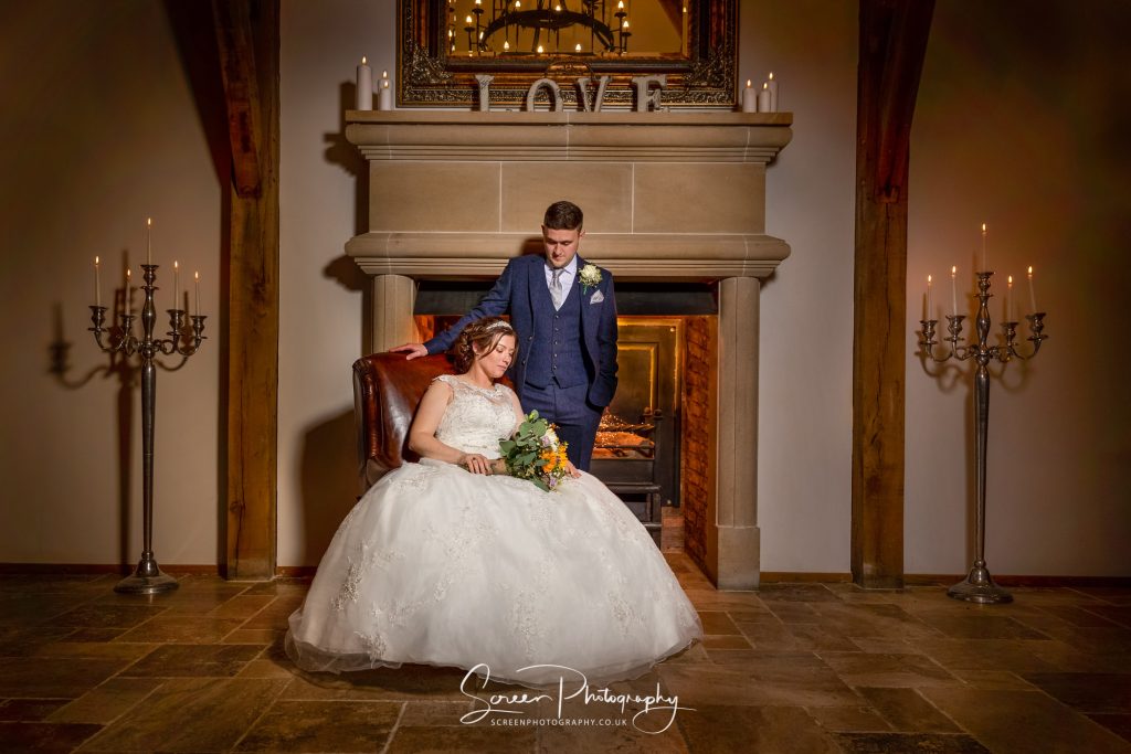 wedding couple in front of Sawncar Farm big fire place in the oak hall