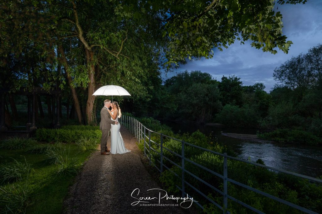couple next to the Derwent at west mill with umbrella flash master award winning image picture silver 