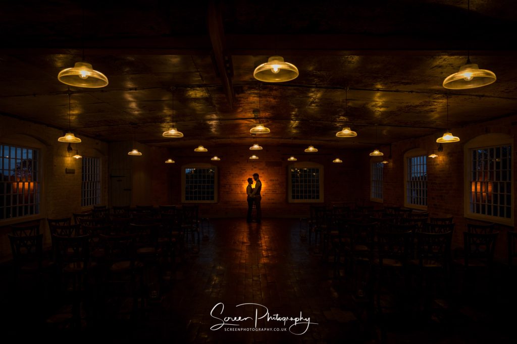 west mill ceremony room with couple at night