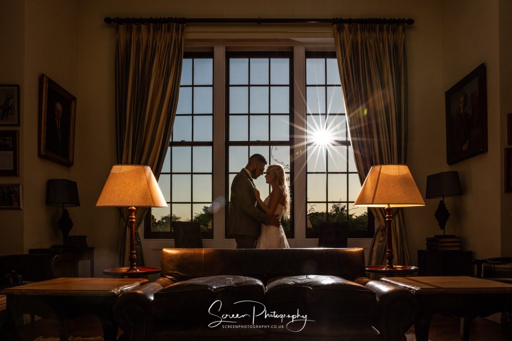 Hodsock priory wedding photographer sun burst through window couple bride groom