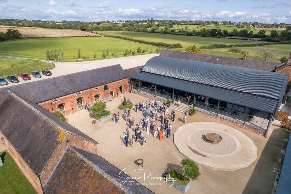 Cripps & Co Grangefields Derby Ashbourne wedding venue barn drone uav aerial view courtyard party guests