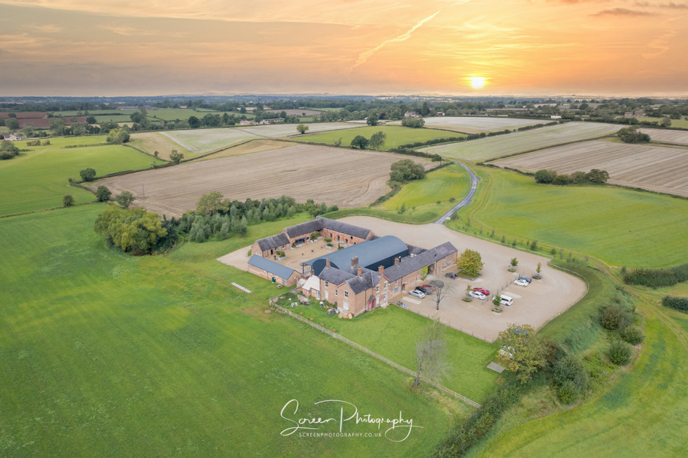 Cripps & Co Grangefields Derby Ashbourne wedding venue barn drone uav aerial view sunset