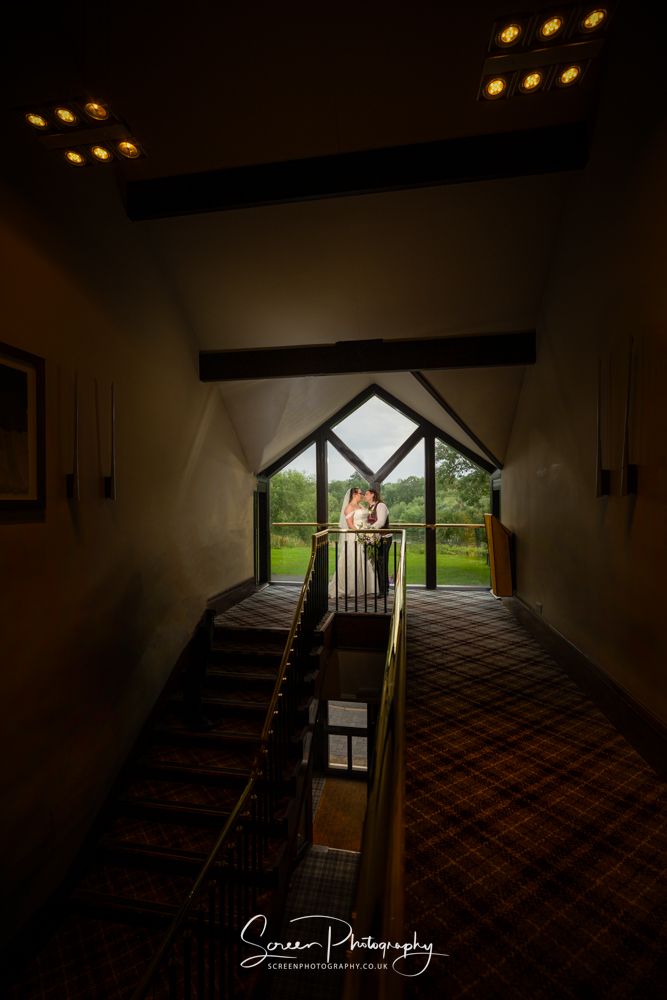 The priest house by the river castle Donington Derbyshire wedding venue hotel stairs married couple lit