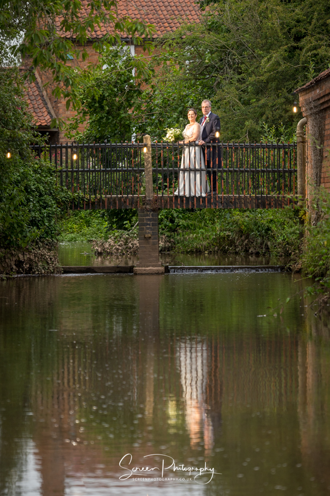 The Mill Hoveringham wedding watermill venue with bridge couple reflection 
