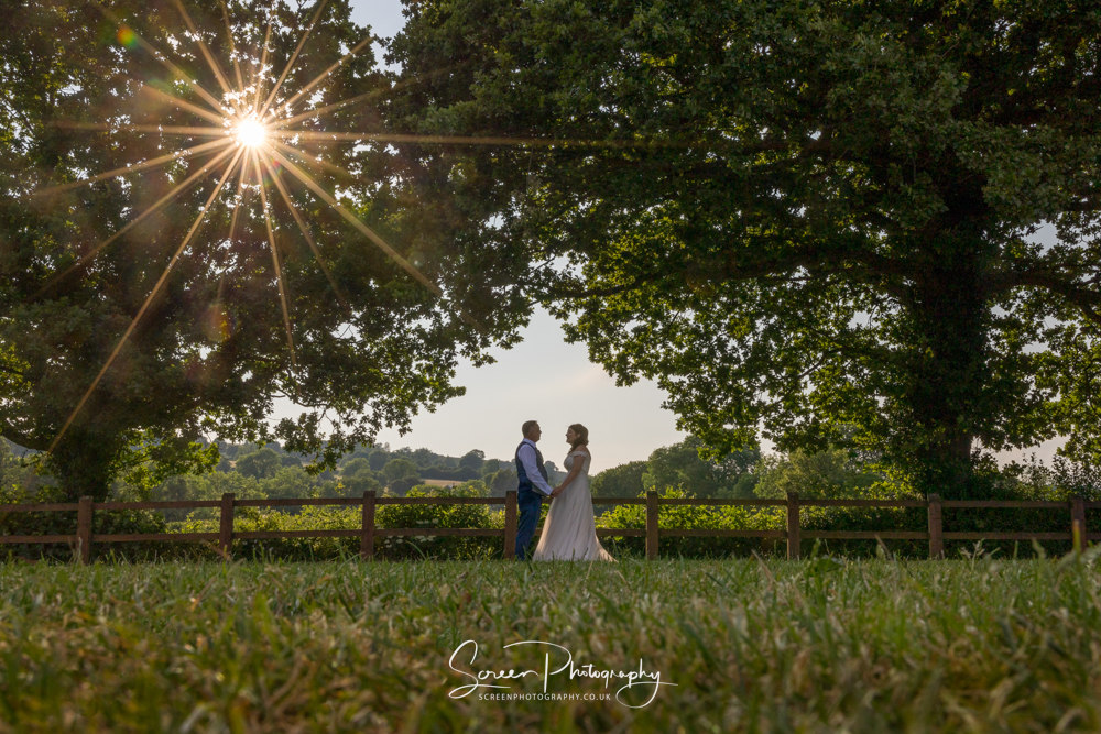 The white hart inn moorwood moor Alfreton wedding venue photography sunset sunburst couple framed woodland trees