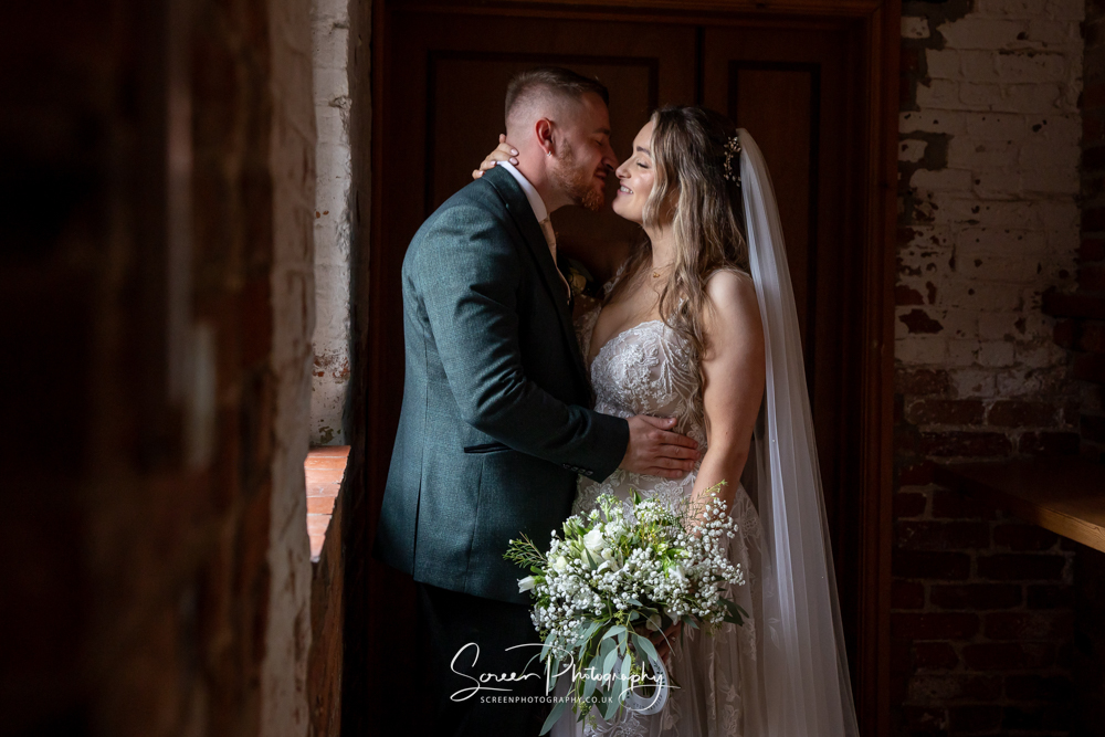 Donington Park Farm house Barn wedding venue bride and groom in natural light window