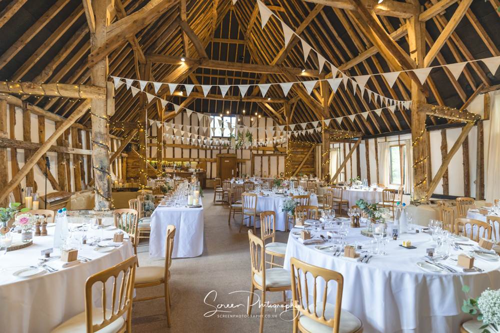 Clock Barn rustic wedding venue Hampshire wedding breakfast room full decor