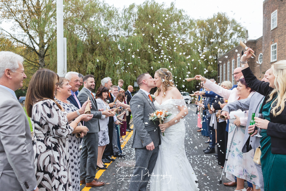 the derby conference centre couple bride groom outside art deco having confetti thrown over them