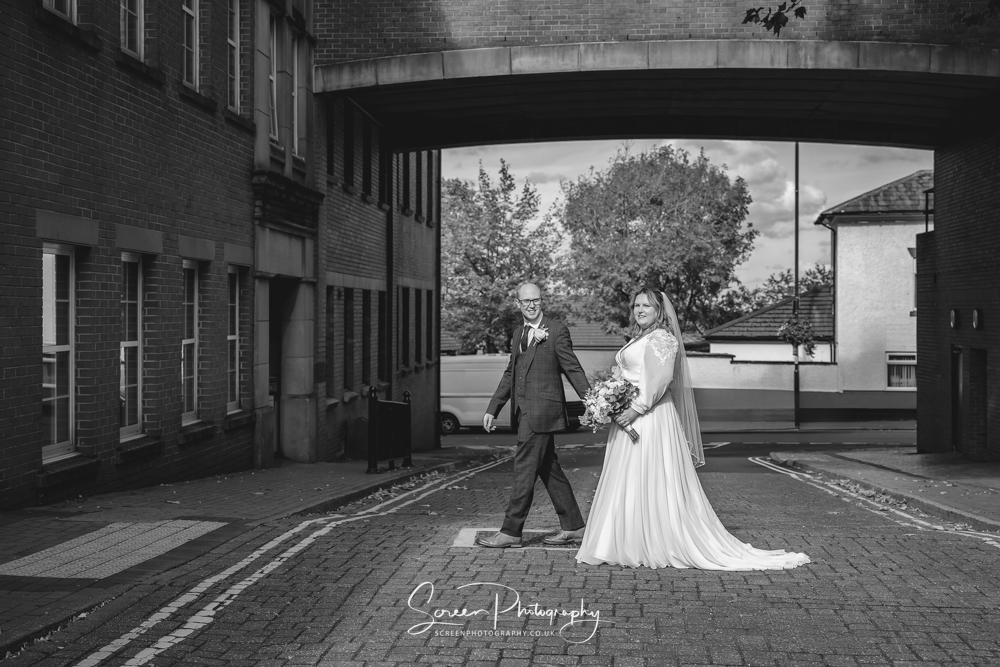 Derby wedding photographer married couple in Ripley walking across the road bride groom