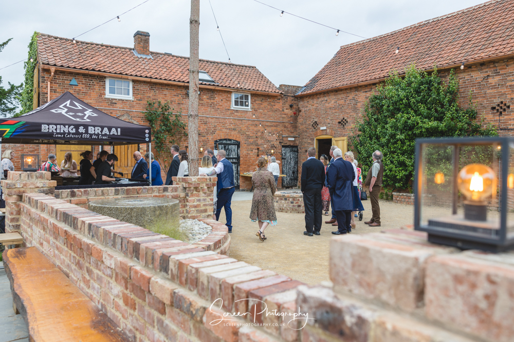 The Mill Hoveringham wedding barn watermill venue near Newark outdoor self catering braai with guests