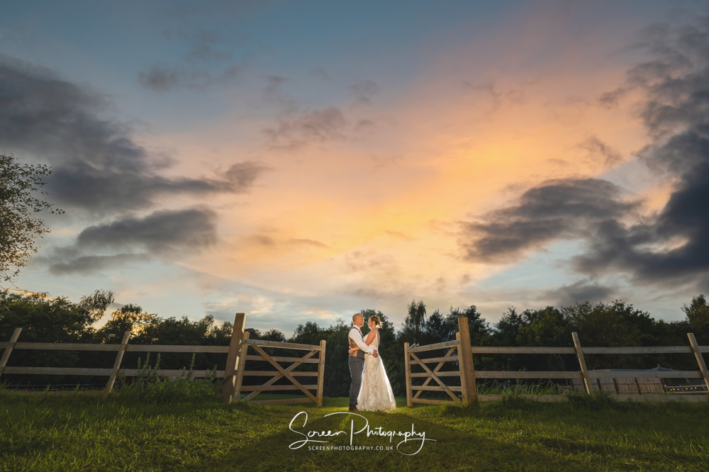 Overgrown Acres tipi countryside wedding venue Nottingham sunset dusk gate off camera flash epic wow married big day clouds