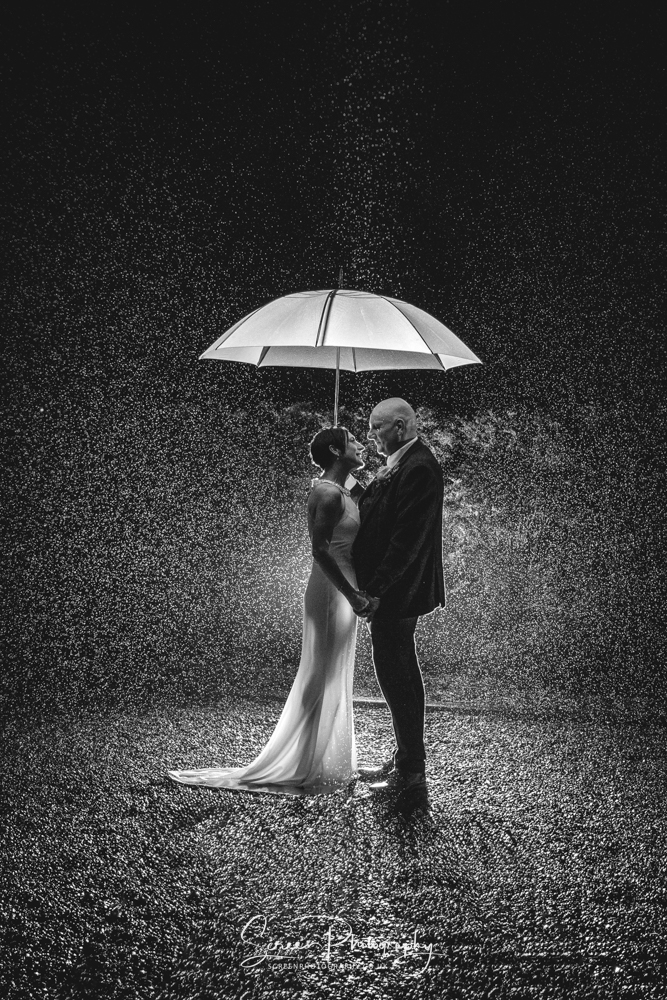 Bride groom wet wow epic wedding day raining umbrella photograph image monochrome black white
