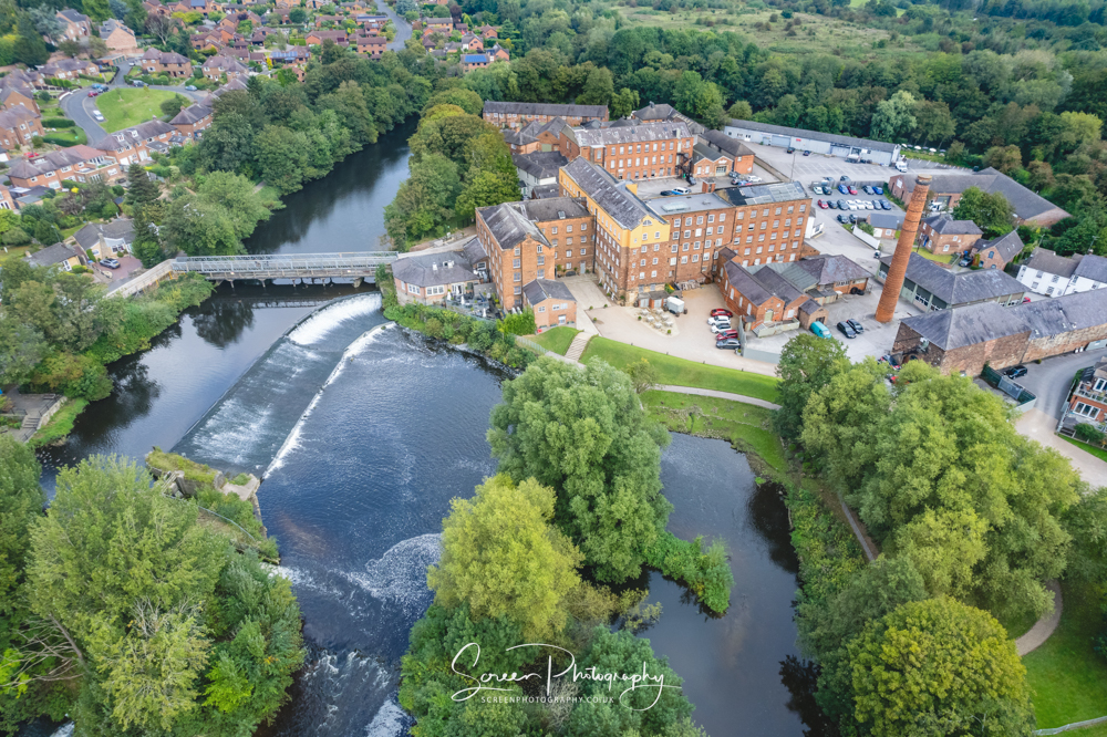 the west mill Darley abbey derby with River Derwent weir by drone