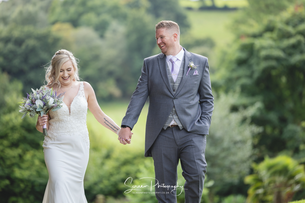 The white hart inn moorwood moor Alfreton wedding venue natural candid photography married couple walking hand in hand