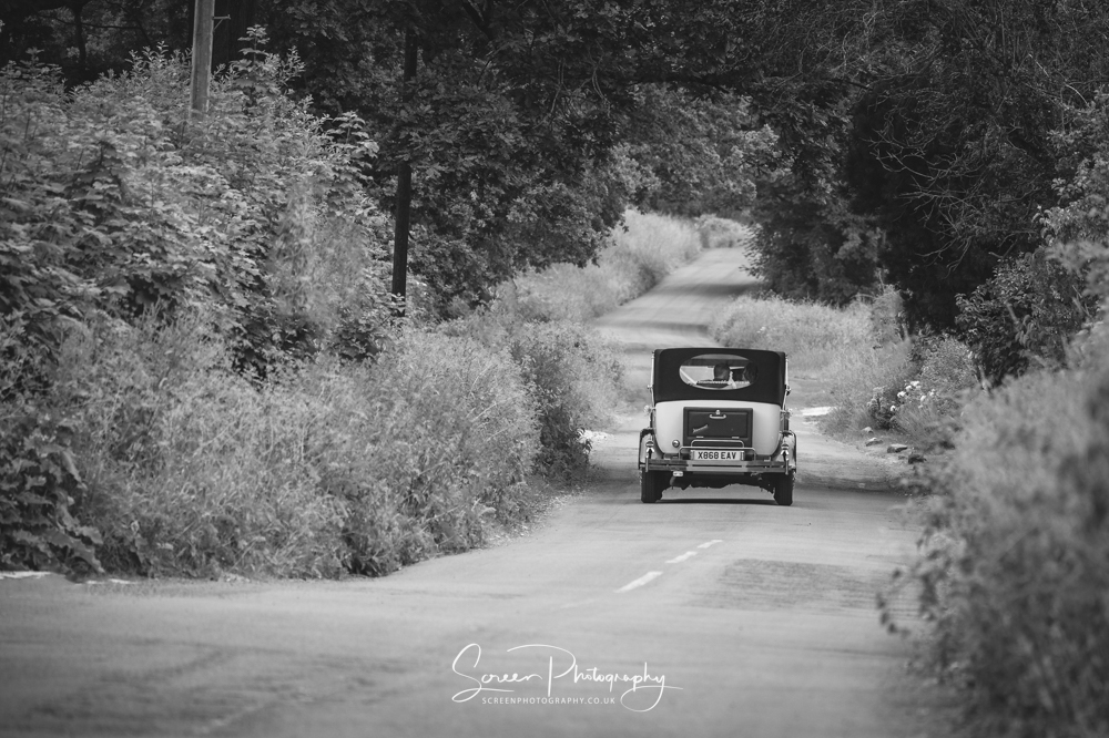 The white hart inn moorwood moor Alfreton wedding venue photography couple driving classic car lane