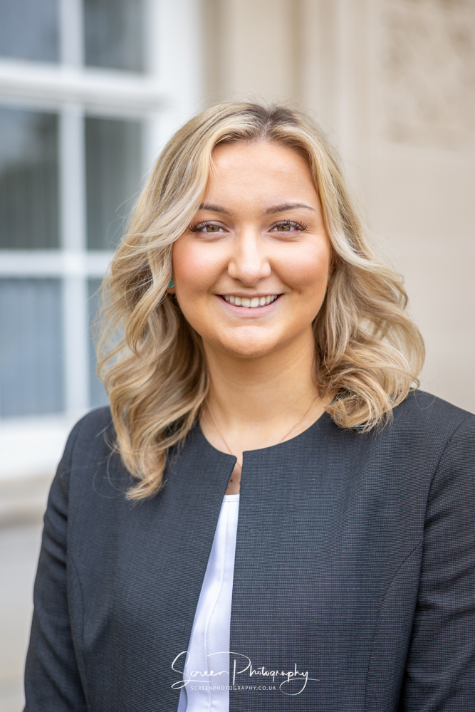 commercial photography nottingham business corporate headshot of a lady outside of her work place in a ladies suit