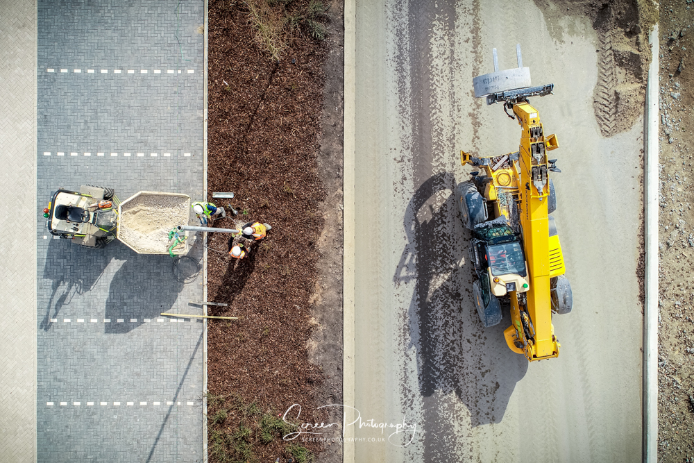 construction-drone-nottingham work men installing a lamp post withfrom dumper truck and telehandler