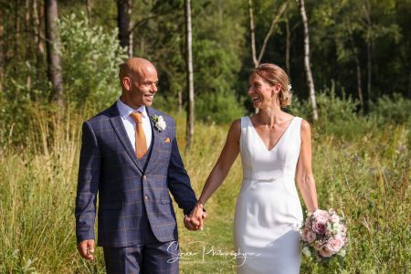 darwin lake wedding photography bride groom walking hand in hand in forest