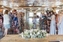 The west mill wedding photography flower boy walking down the ceremony aisle