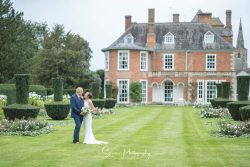 sutton bonington hall wedding photography bride groom on lawn infront of house