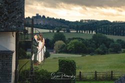 donington park farmhouse wedding photography bride groom on stairs at sunset