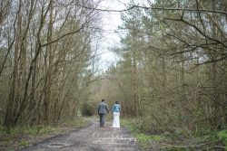 Peak District Matlock Darwin lake wedding venue married couple walking in woods with denim jacket
