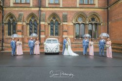 the renaissance kelham hall wedding photography bride groom with bridal and groomsmen in rain