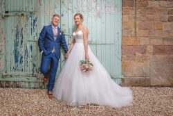 Shottle Hall wedding venue derby Derbyshire married couple bride groom infant of textured barn doors