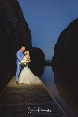 burgh island wedding photohraphy bride groom on pontoon at blue hour dusk