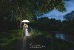 The west mill derby mills married couple bride groom at blue hour with umbrella creative picture side of Derwent river