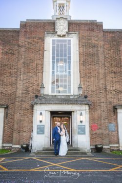 derby conference centre bride and groom in front of building