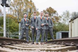 derby conference centre wedding photography groom party on train tracks