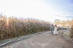stretton manor barn wedding photography bride groom walking down lane in frost at sunset