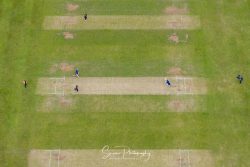 commercial drone nottingham of Elvaston Castle cricket game in the air with cricketers running between wickets