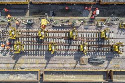 commercial drone nottingham aerial view looking down over willesden junction london new train tracks being laid fitted during the day with rail workers around
