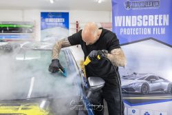 commercial photography nottingham windcreen protection film being steam applied onto wind shield