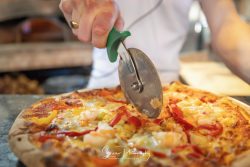commercial photography nottingham pizza shop cafe being cut rolled by chef