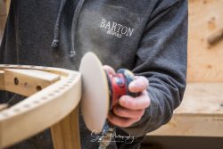 commercial photography nottingham branded upholstery wood making person sanding down furniture frame