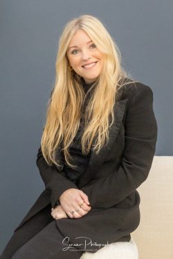 commercial photography nottingham business corporate headshot of a lady sat on a sofa with hands on lap