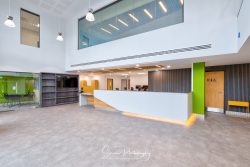 commercial photography nottingham high ceiling reception area with desk table chairs double height glazing and wood panelling
