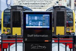 commercial photography nottingham staff information train station electronic display board with trains in background distance