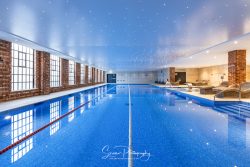 commercial photography nottingham swimming pool with twinkle lights above windows reflections and loungers