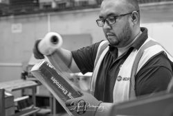commercial photography nottingham showing a man in hi-viz jacket wrapping goods in a warehouse