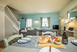 commercial photography nottingham peak district holiday cottage airbnb showing laid dining table with food cheese proseco and lounge area